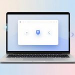 A laptop displaying a white browser window with a blue shield icon in the center. The background is a gradient of pastel pink and blue.