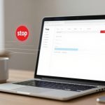 A laptop on a table displays a web browser with a "stop" icon hovering above it. A white coffee mug is beside the laptop.