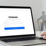 A laptop displaying a webpage titled "Chitikotts" with a white background. The screen shows text fields and a blue button. A hand is using a mouse next to the laptop. A translucent silhouette of a person with a cane is superimposed on the right. The setting appears to be an office.