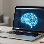 A laptop on a white table displays a digital brain with neural connections in blue light. Beside it, a white coffee cup on a saucer and a spiral notebook are visible. The background features a blurred indoor setting.