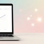 A laptop displays a line graph showing upward trends. The background is a pastel gradient with a glowing, interconnected network of dots.