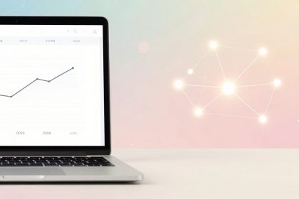 A laptop displays a line graph showing upward trends. The background is a pastel gradient with a glowing, interconnected network of dots.