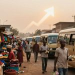 A busy street market with vendors selling produce like tomatoes and textiles. People walk between parked vans. A white upward arrow is superimposed in the sky.
