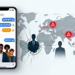 A smartphone displaying a chat app with emojis and text overlays a world map. Red alert icons are marked on Asia and Europe. Silhouettes of people and a cracked glass effect are visible on the map.