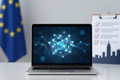 A laptop displaying a digital network diagram with glowing nodes on a desk. An EU flag is in the background, next to a clipboard with a checklist and a city skyline cutout.