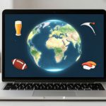 A laptop displays a digital globe with a beer glass, American football, sushi, and a pickaxe around it. Two cups are on each side of the laptop.