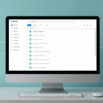 A desktop computer displaying a file management application on the screen, featuring a sidebar with icons and a list of documents. The background is teal with floating document icons connected by lines, suggesting file sharing or organization. A keyboard and mouse are on the desk.