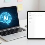 A laptop and tablet on a desk. The laptop screen displays a digital brain with "AI" in blue. The tablet shows a blank document.