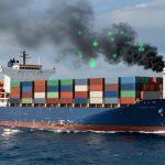 A blue cargo ship at sea with stacked colorful containers. Black smoke emerges from the smokestack, and green digital icons overlay the smoke.