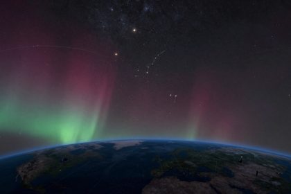 Earth's horizon with vivid green and red auroras in the atmosphere, starry night sky above with visible constellations and stars.