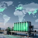 A futuristic energy facility in a snowy landscape, with large green-lit cylindrical tanks and wind turbines. A glowing world map overlays the sky.