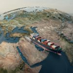 A large container ship sails on a stylized globe, passing between Europe and Asia. The ship carries multicolored cargo containers. A port with cranes and stacked containers is visible in the background. Bright blue lines highlight routes on the globe.