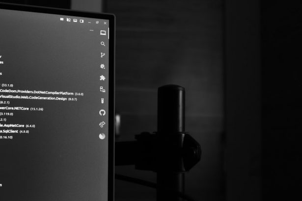 A computer monitor displaying lines of code in a darkened room, illustrating a local AI coding agent running on a developer machine