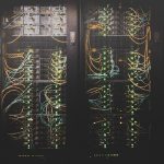 Dense rows of network cables in a data centre, illustrating the AI inference routing layer Stripe is acquiring with OpenRouter