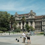People gathered in front of a grand historic courthouse building, illustrating the Argentine federal court where Editorial Perfil filed its lawsuit against OpenAI and Microsoft