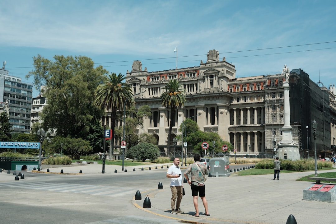 People gathered in front of a grand historic courthouse building, illustrating the Argentine federal court where Editorial Perfil filed its lawsuit against OpenAI and Microsoft
