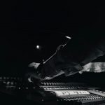 Studio mixing console in black and white, illustrating disclosure of AI-generated music on streaming platforms