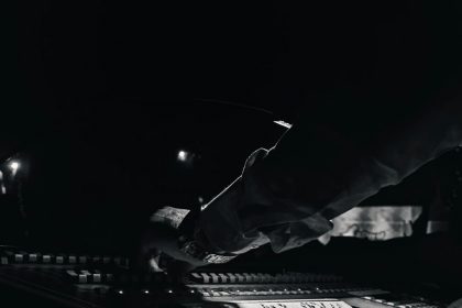 Studio mixing console in black and white, illustrating disclosure of AI-generated music on streaming platforms