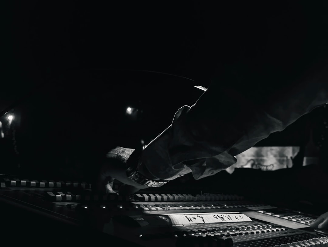 Studio mixing console in black and white, illustrating disclosure of AI-generated music on streaming platforms